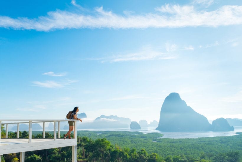 A woman looks out over a mountain view in Khao Samed Nang Chee Viewpoint in Thailand | © weedezign/Shutterstock