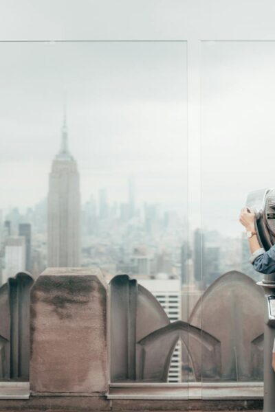 woman in blue denim jacket standing on top of building